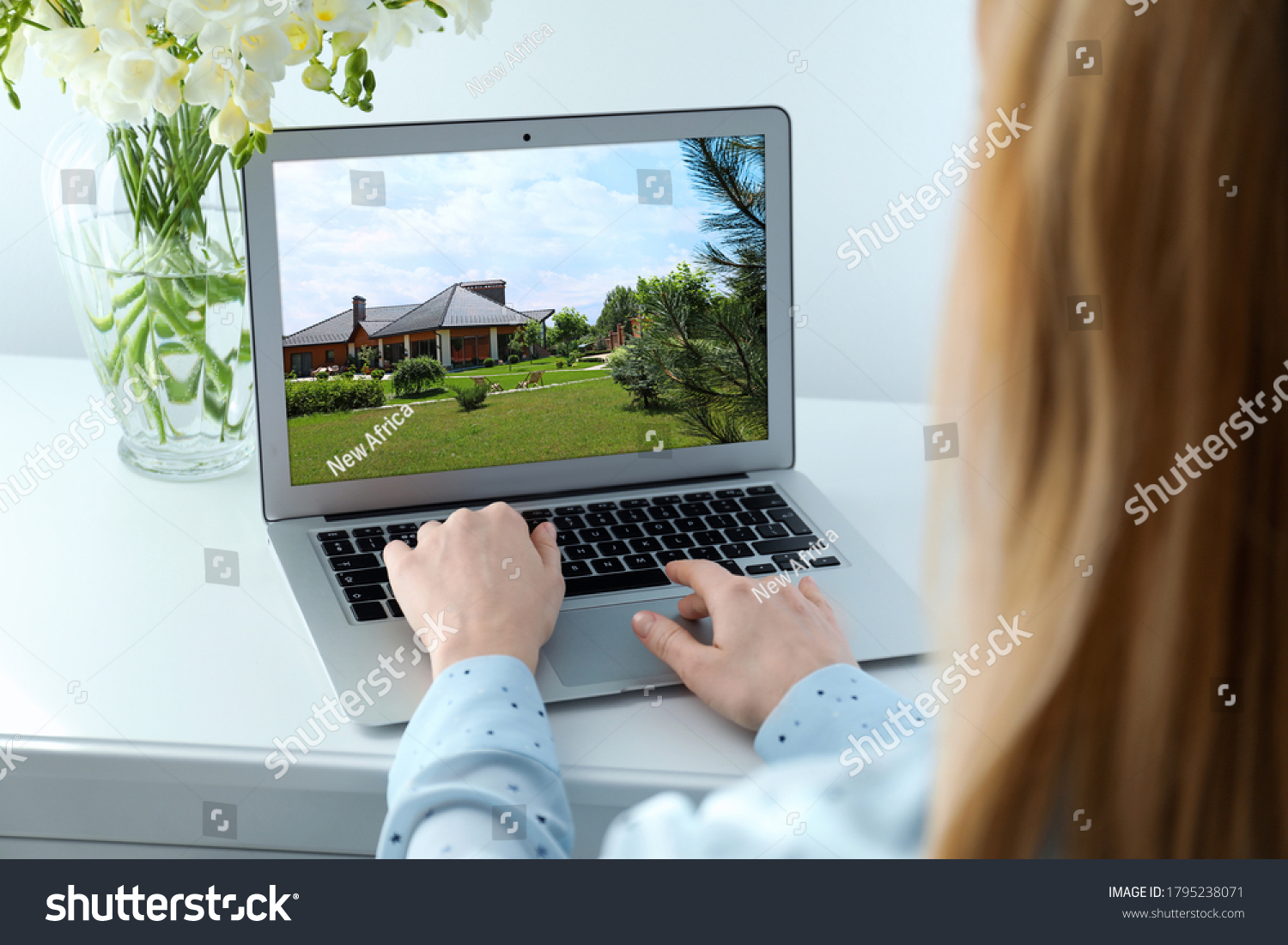 Woman choosing new house online using laptop or real estate agent working at table, closeup #1795238071