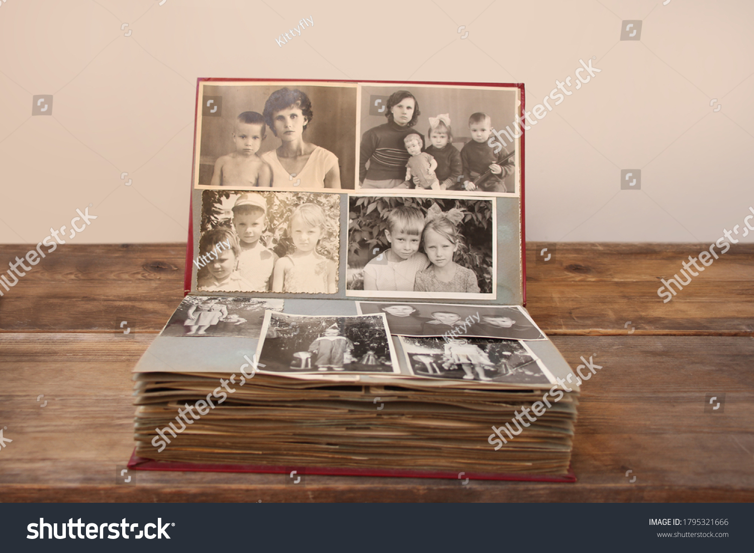 old retro album with vintage monochrome photographs in sepia color, taken in 1955-1960, concept of genealogy, the memory of ancestors, family ties, childhood memories #1795321666