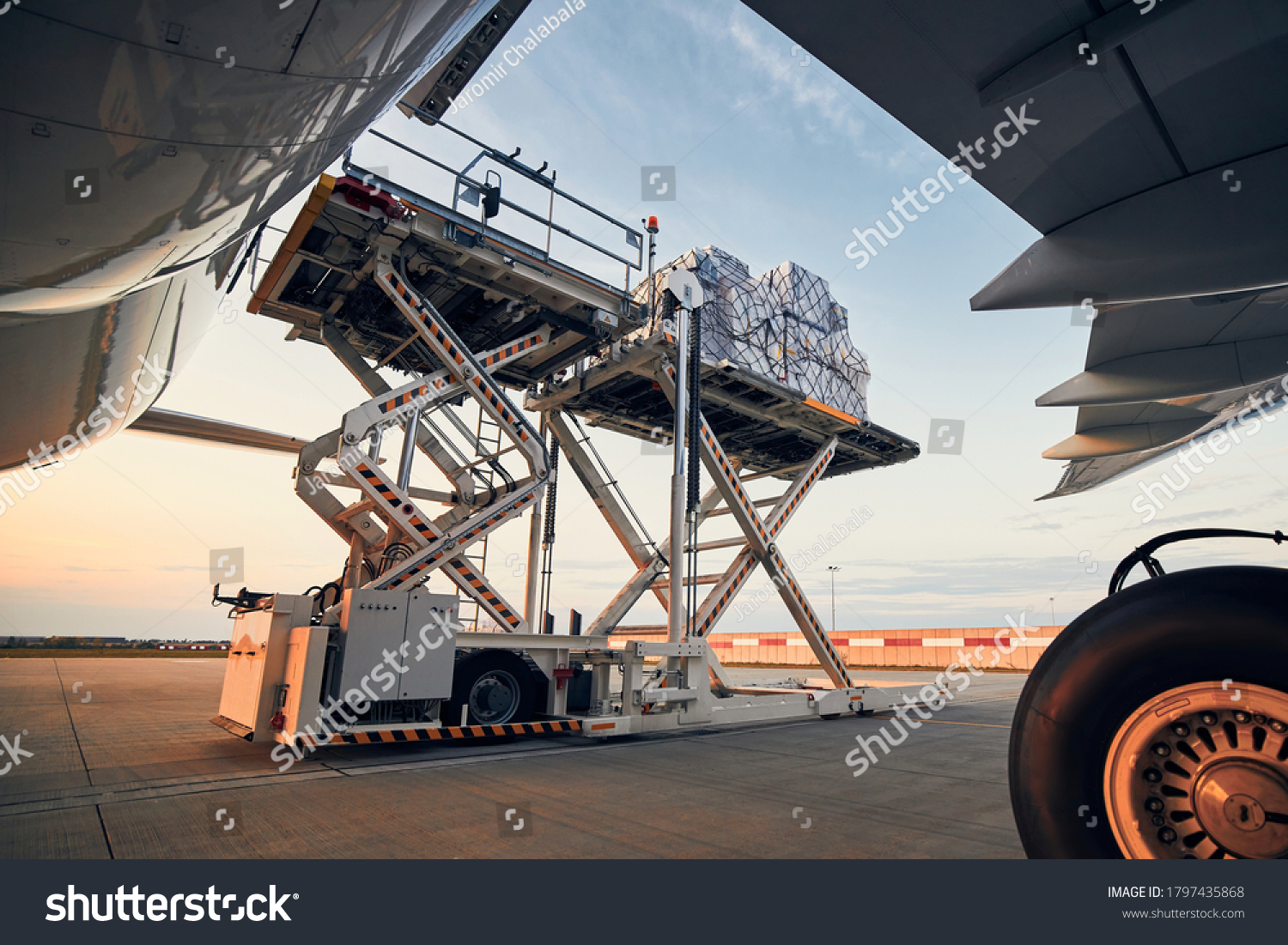 Preparation before flight. Loading of cargo containers to airplane at airport. #1797435868