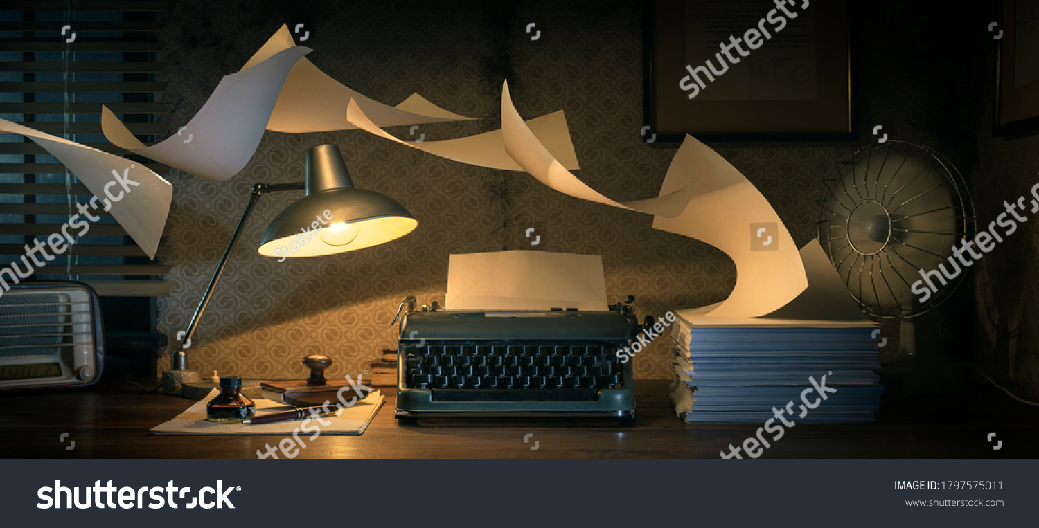 Vintage writer's desktop with typewriter and flying sheets, creativity and inspiration concept #1797575011