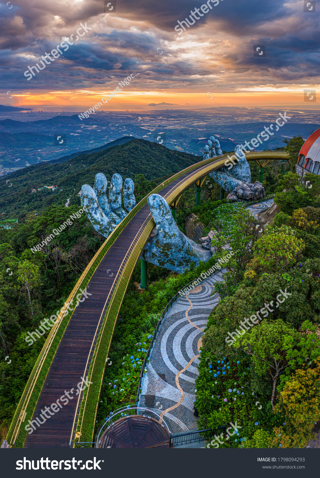 Aerial view of the Golden Bridge is lifted by two giant hands in the tourist resort on Ba Na Hill in Da Nang, Vietnam. Ba Na mountain resort is a favorite destination for tourists #1798094293