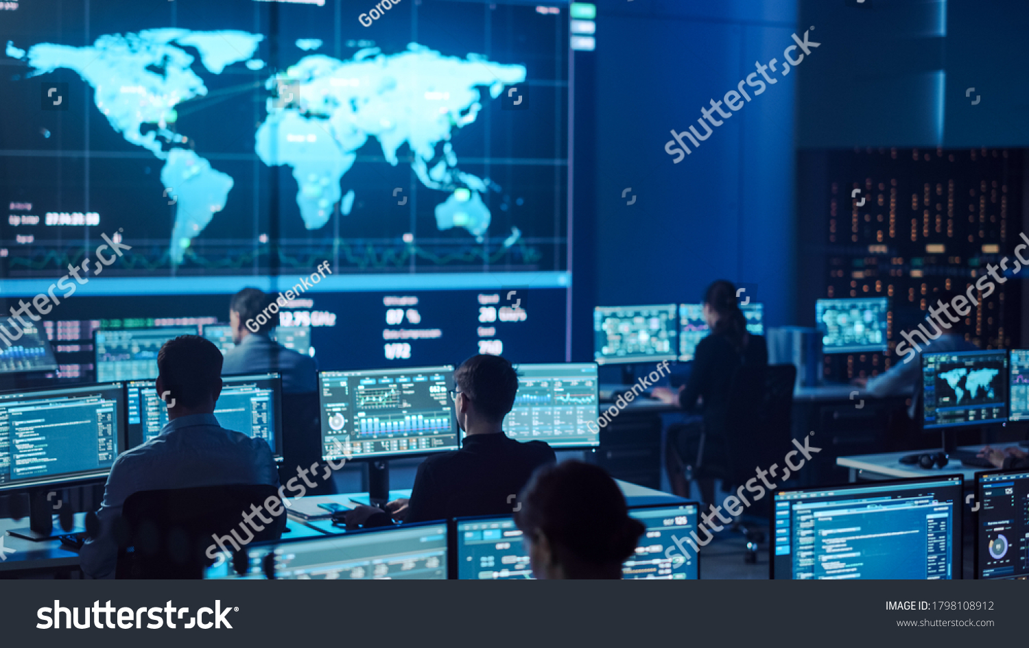 Team of Professional Computer Data Science Engineers Work on Desktops with Screens Showing Charts, Graphs, Infographics, Technical Neural Network Data and Statistics. Dark Control and Monitoring Room. #1798108912