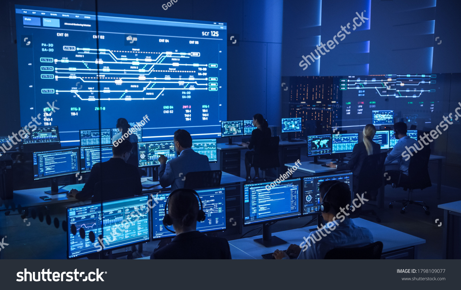 Team of Professional Computer Data Science Engineers Work on Desktops with Screens Showing Charts, Graphs, Infographics, Technical Neural Data and Statistics. Low Key Control and Monitoring Room. #1798109077