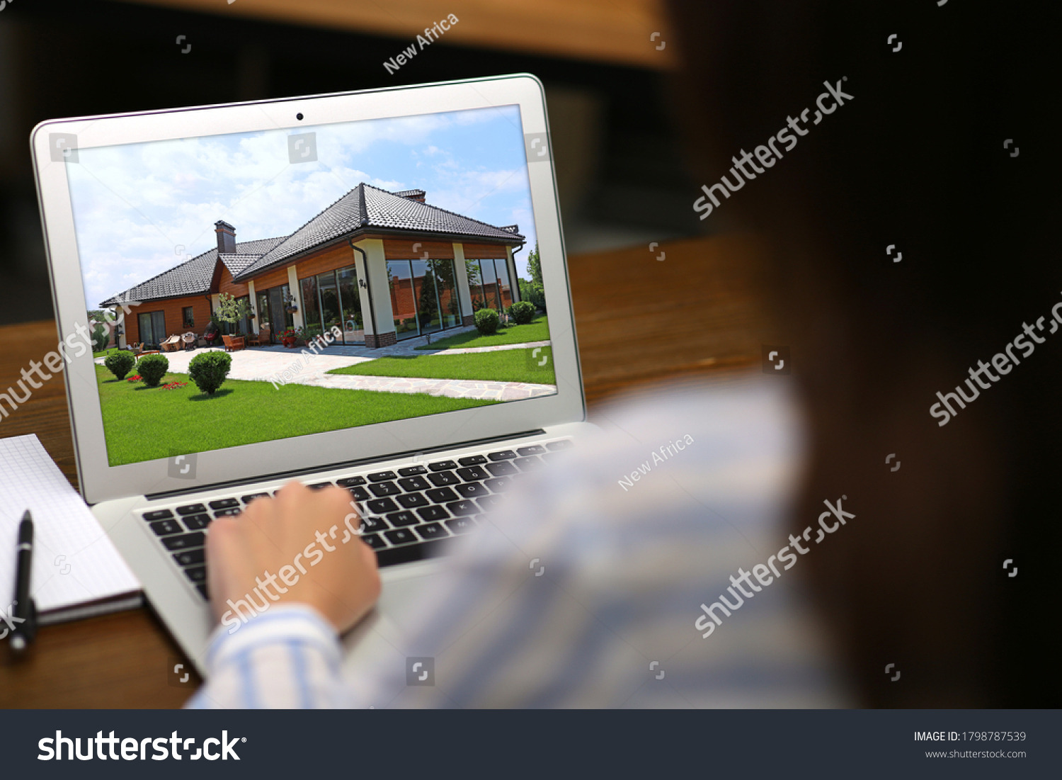 Woman choosing new house online using laptop or real estate agent working at table, closeup #1798787539