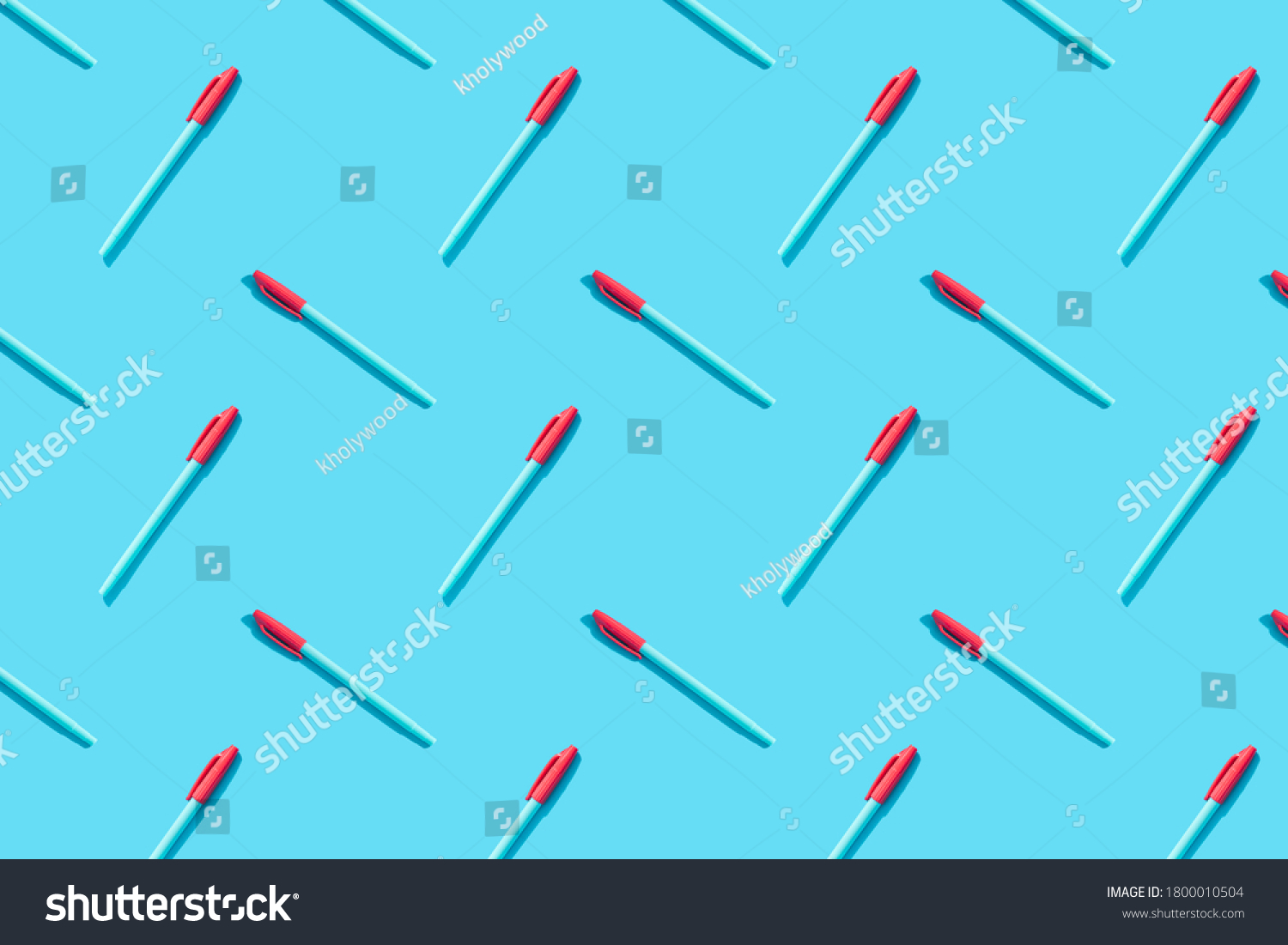 Blue pens with red caps lie on a blue background. The concept of training, business, school, office. Minimalism, copy space, pattern. #1800010504