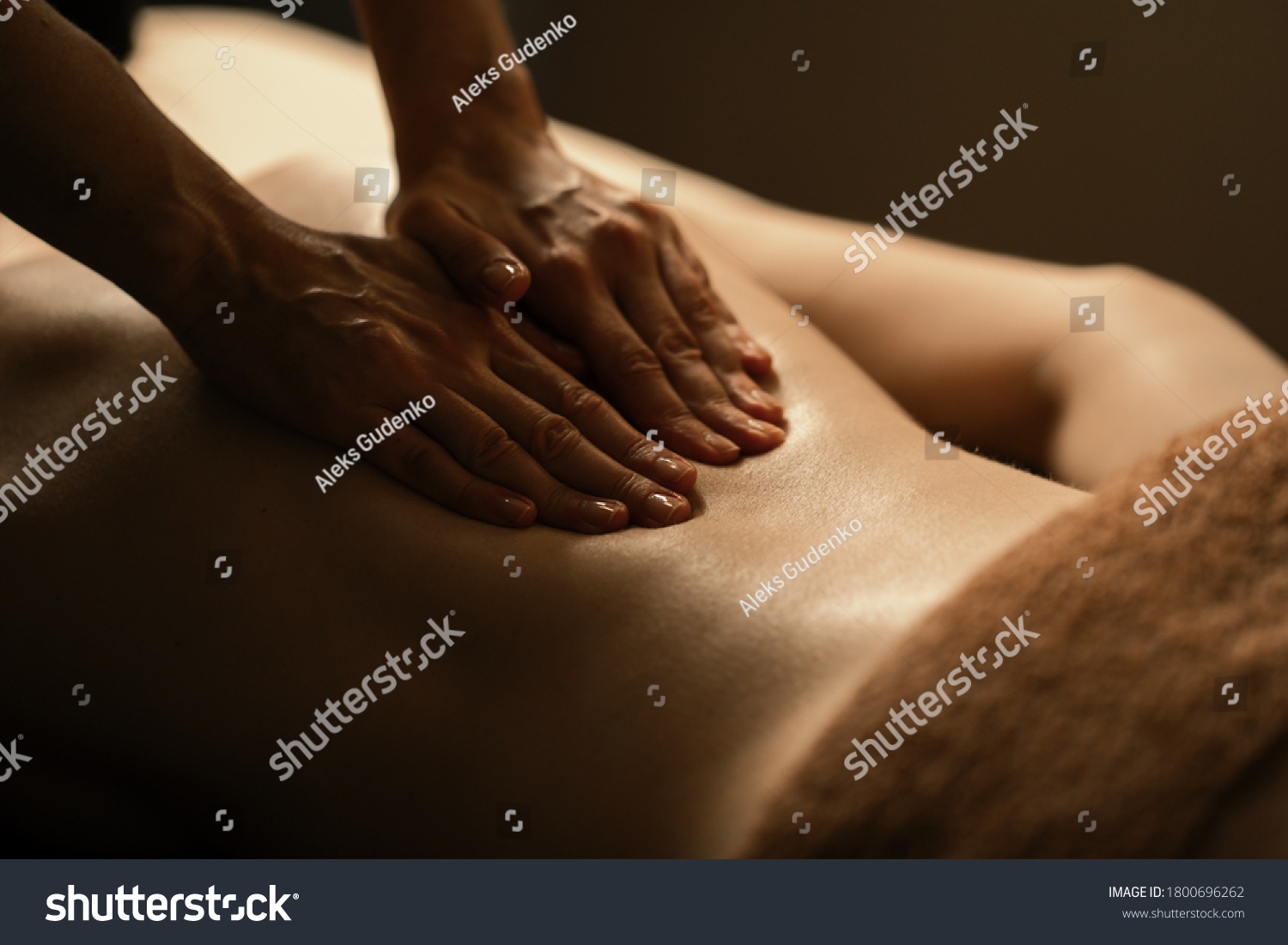 The beautiful girl has massage. Authentic image of luxury spa treatment. Warm colors, charming light. #1800696262