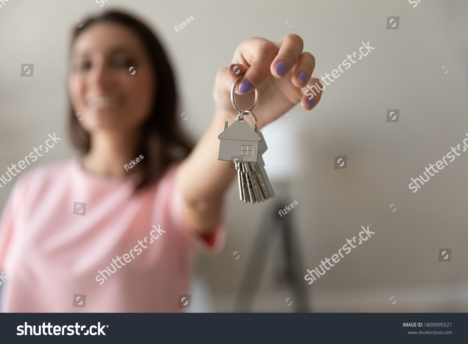 Close up of happy female renter tenant show keys buy purchase first own home or apartment, woman moving relocating to new dwelling, excited client settle in house, relocation, rental, realty concept #1800995521
