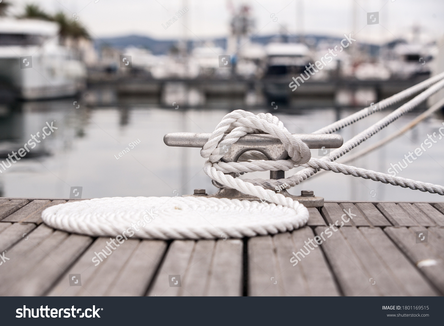 Nautical mooring line rope on the jetty. Curled mooring line. #1801169515