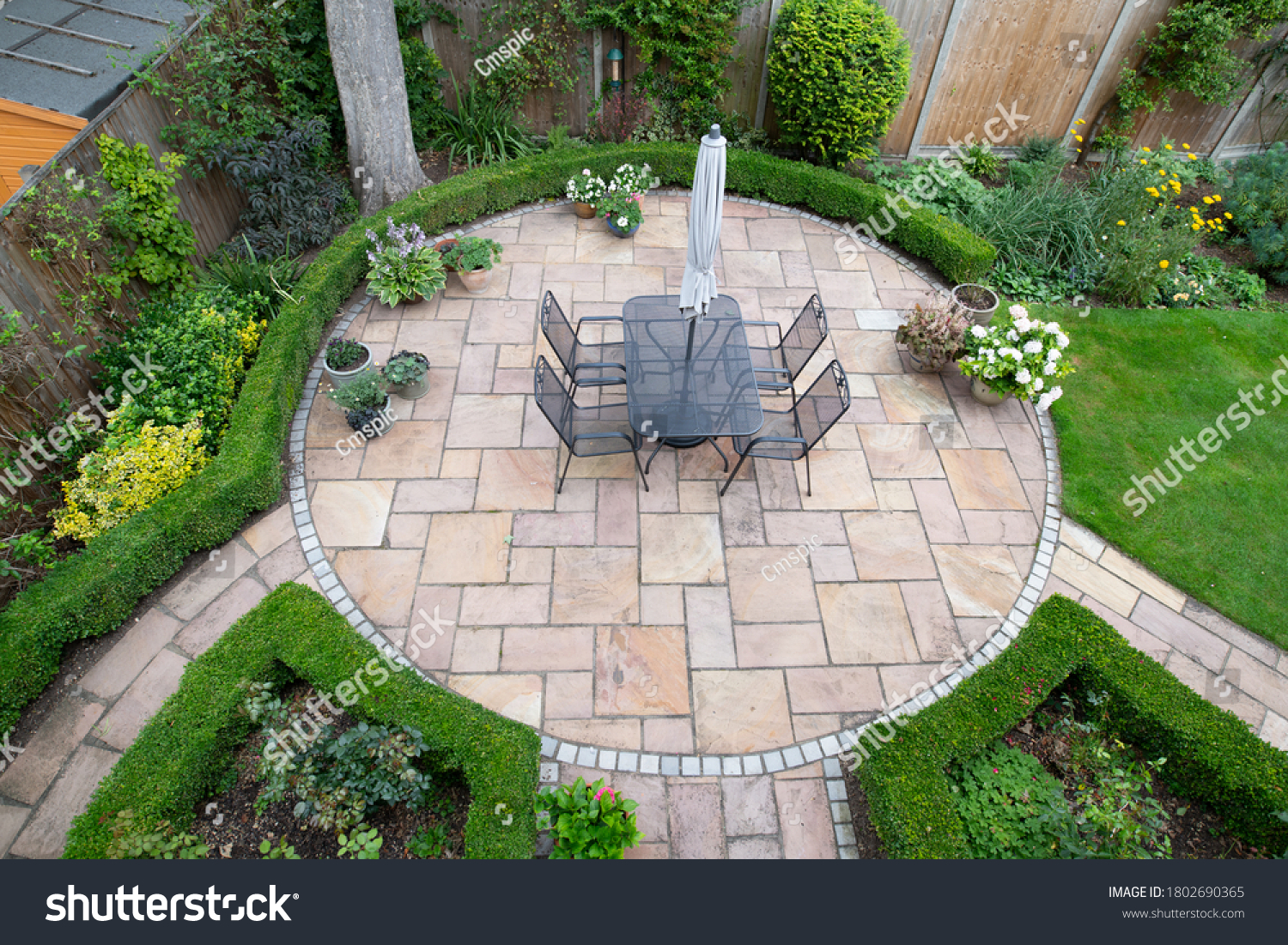 circular garden patio with freshly jet washed paving stones #1802690365