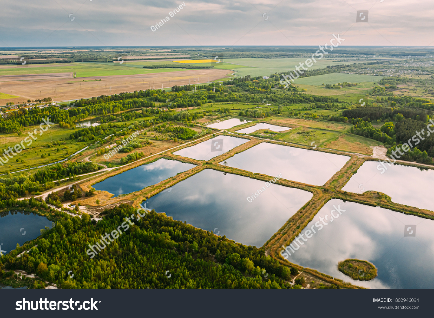 Aerial View Retention Basins, Wet Pond, Wet Detention Basin Or Stormwater Management Pond, Is An Artificial Pond With Vegetation Around The Perimeter, And Includes A Permanent Pool Of Water In Its #1802946094