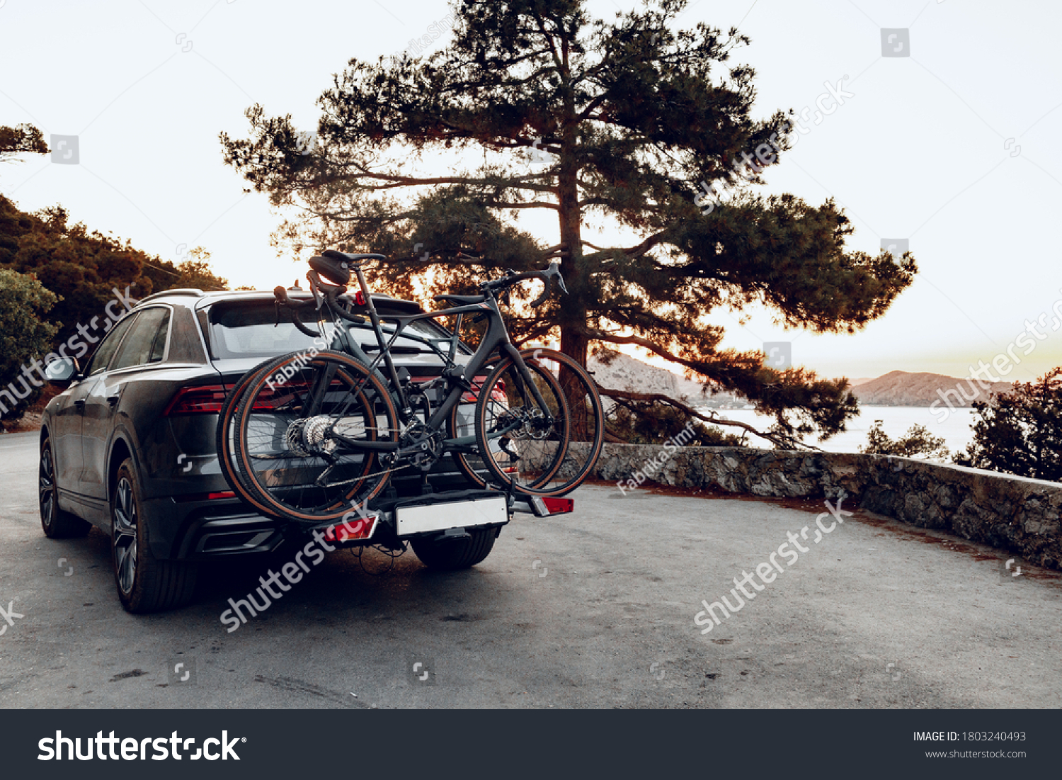 Crossover car with two road bicycles loaded on a rack #1803240493