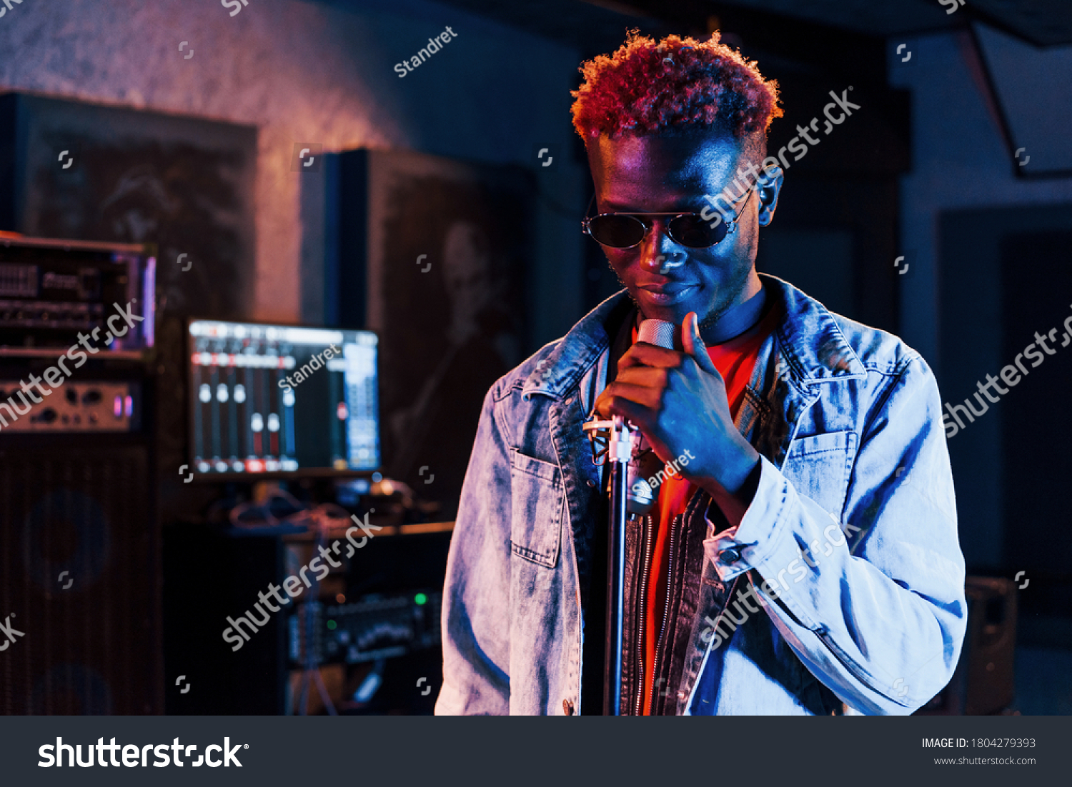 Young african american performer rehearsing in a recording studio. #1804279393