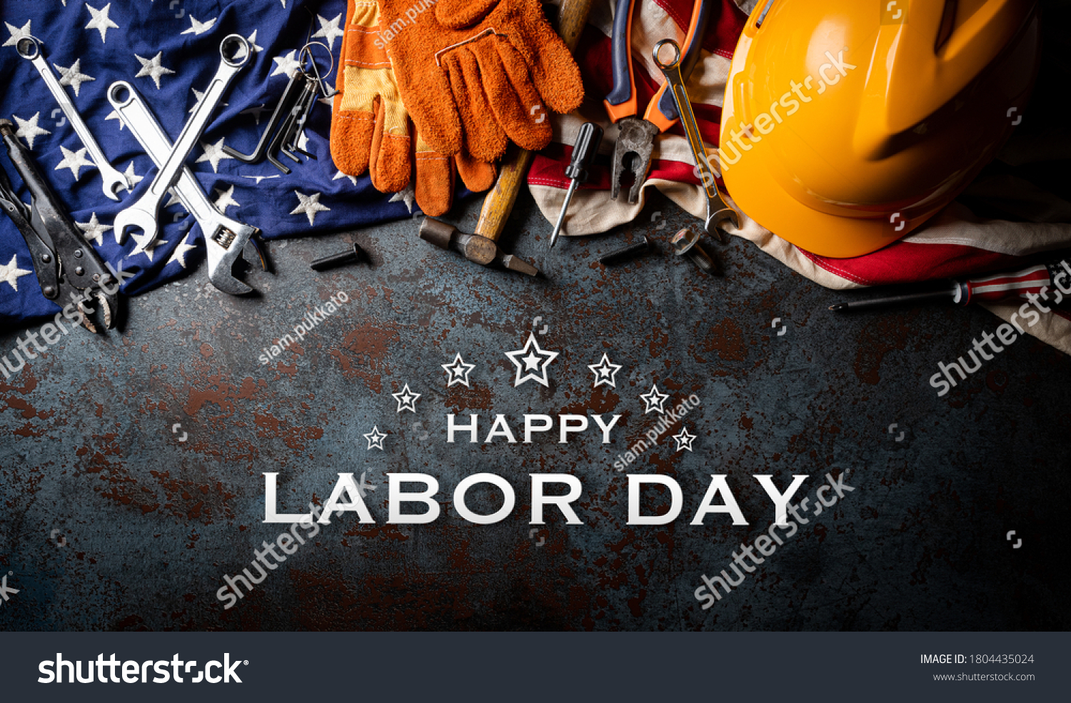 Happy Labor day concept. American flag with different construction tools on dark stone background, with Happy Labor Day text. #1804435024