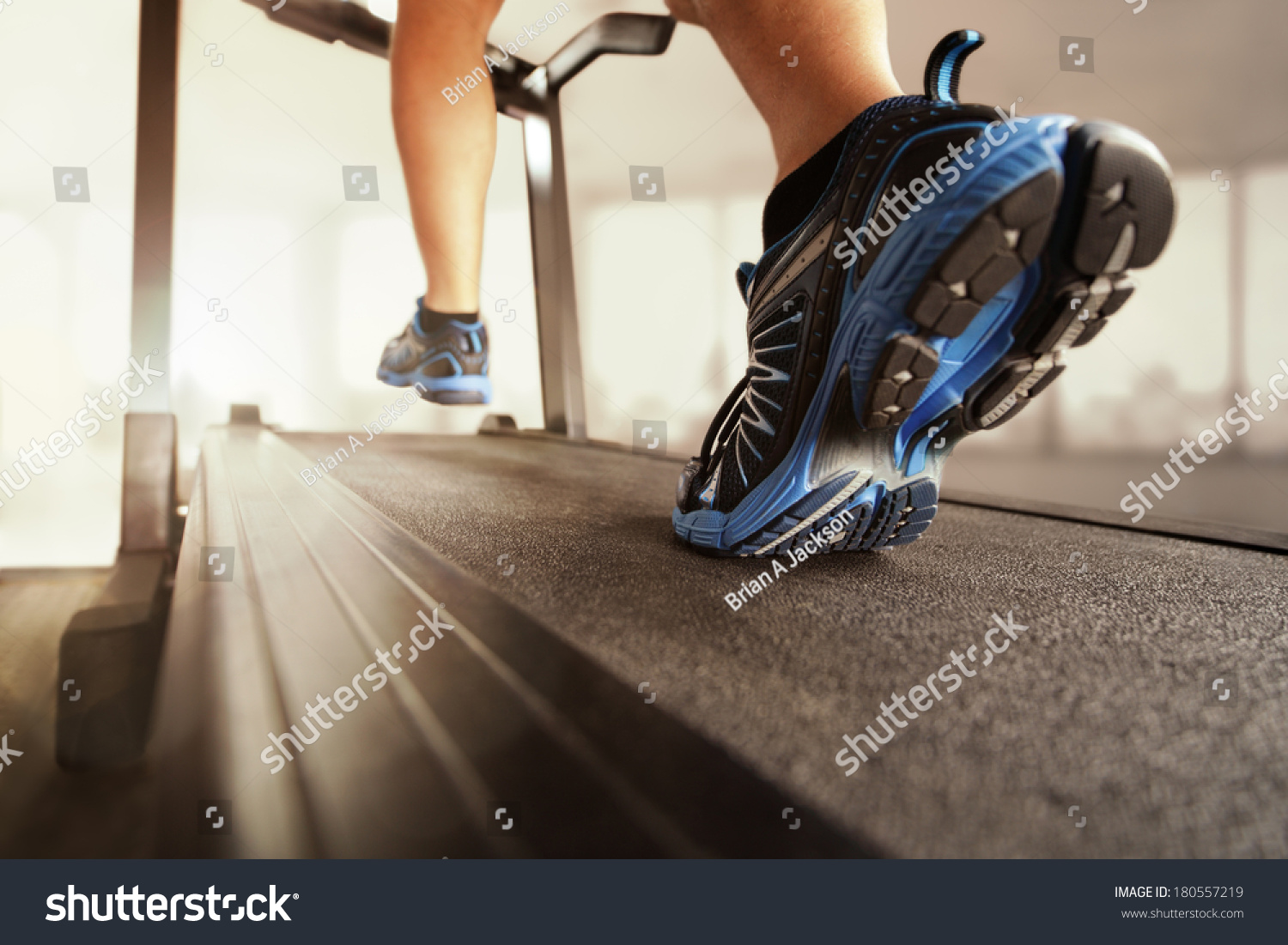 Man running in a gym on a treadmill concept for exercising, fitness and healthy lifestyle #180557219