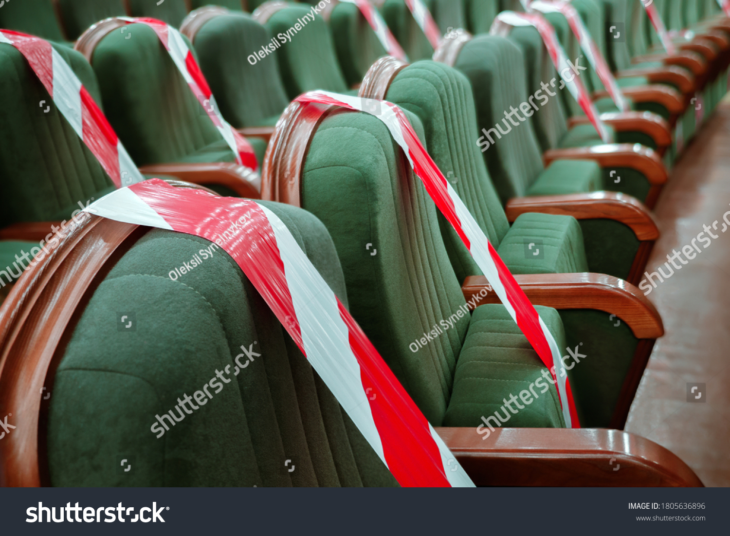 Keep your distance to avoid physical contact. Practice of social distancing. View of rows of seats marked with a warning tape in the cinema, theater, auditorium, conference hall. Protection COVID-19 #1805636896