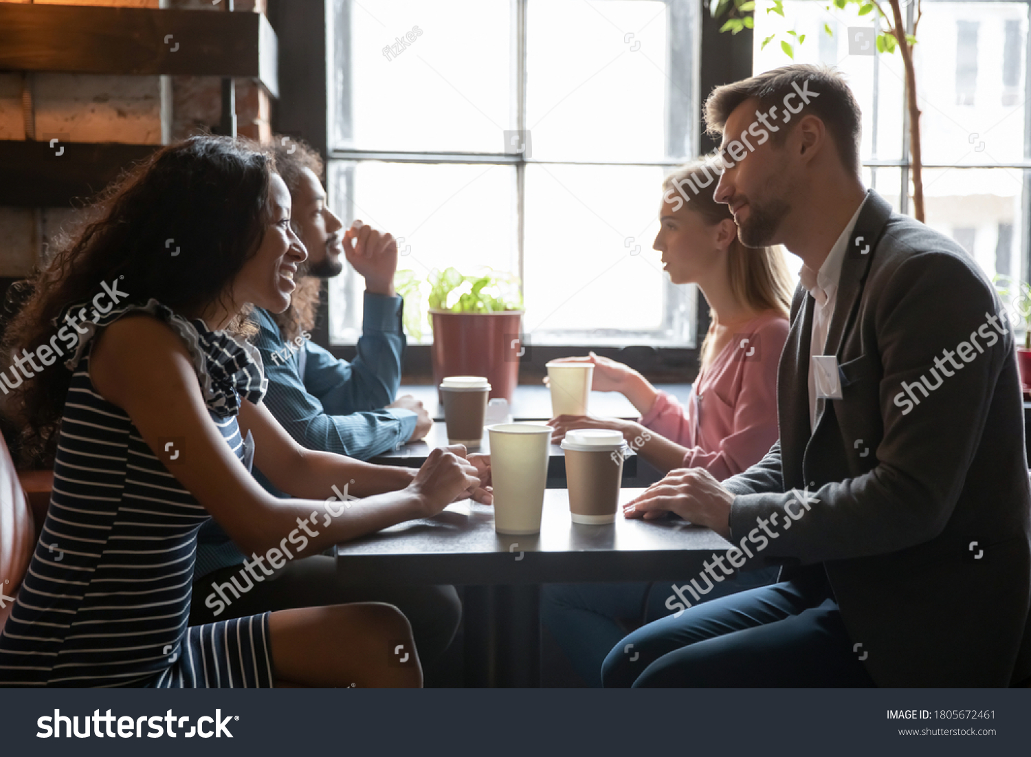 Diverse people sitting in cafe, drinking coffee and talking, chatting, participating in speed dating, young men and women having fun at meeting in coffee house, getting acquaintance #1805672461