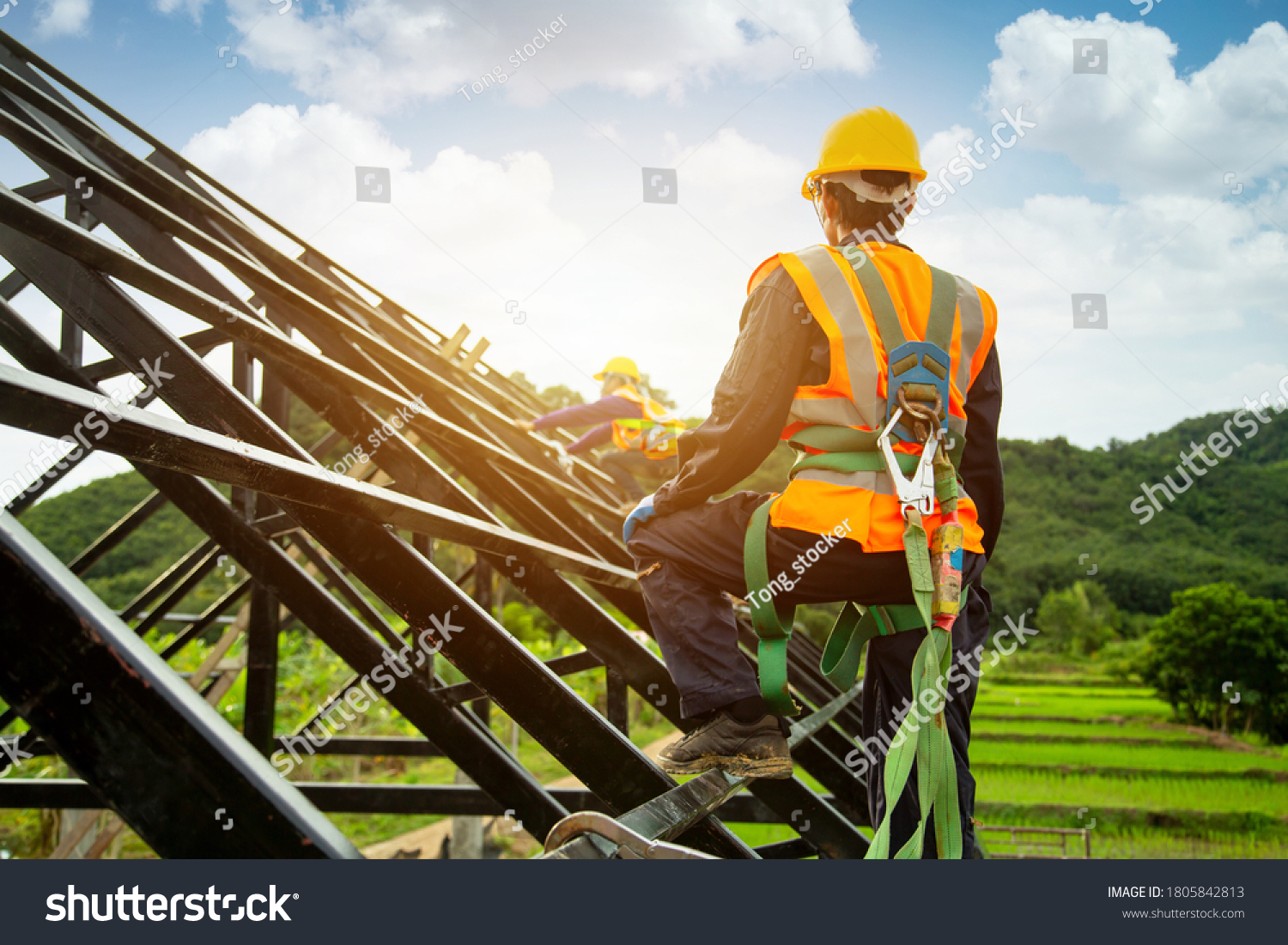 Asian worker wear safety height equipment to install the roof. Fall arrestor device for worker with hooks for safety body harness, Worker as in the construction site
 #1805842813