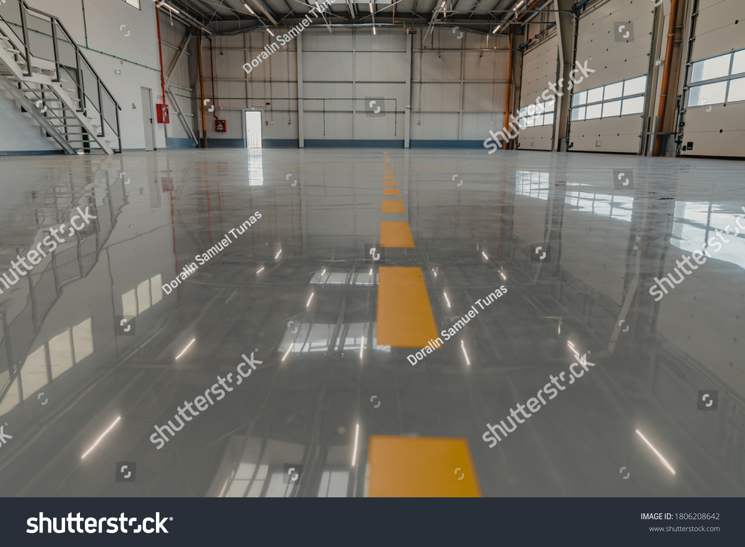 Epoxy and waxed flooring with colorful signage in car service #1806208642