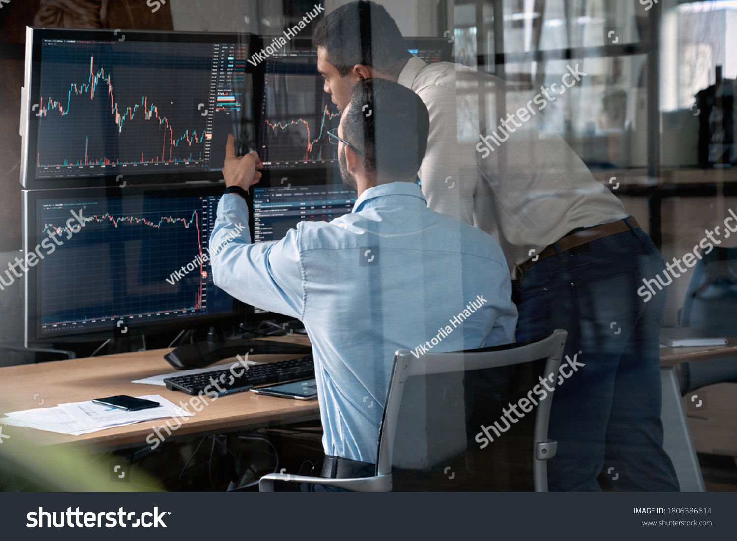 Two businessman working in office together, pointing at screen, discussion and checking global currency index on fund exchange #1806386614