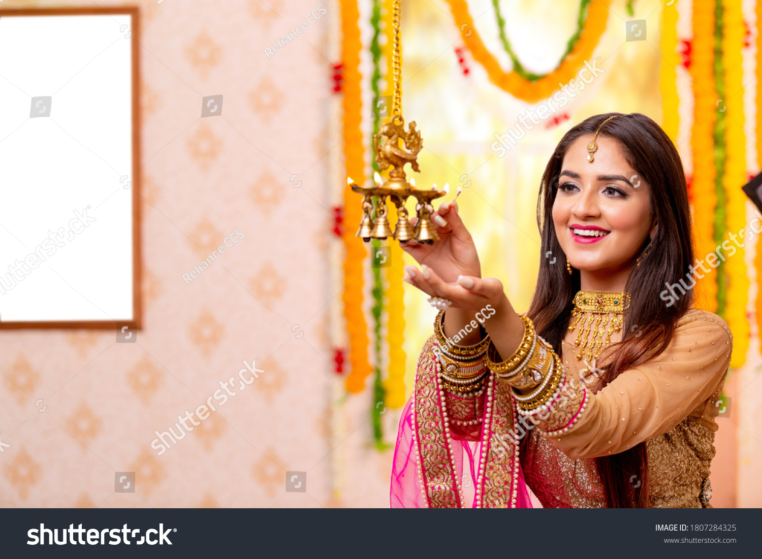 Female Celebratiing diyas Decoration  for diwali festival. #1807284325