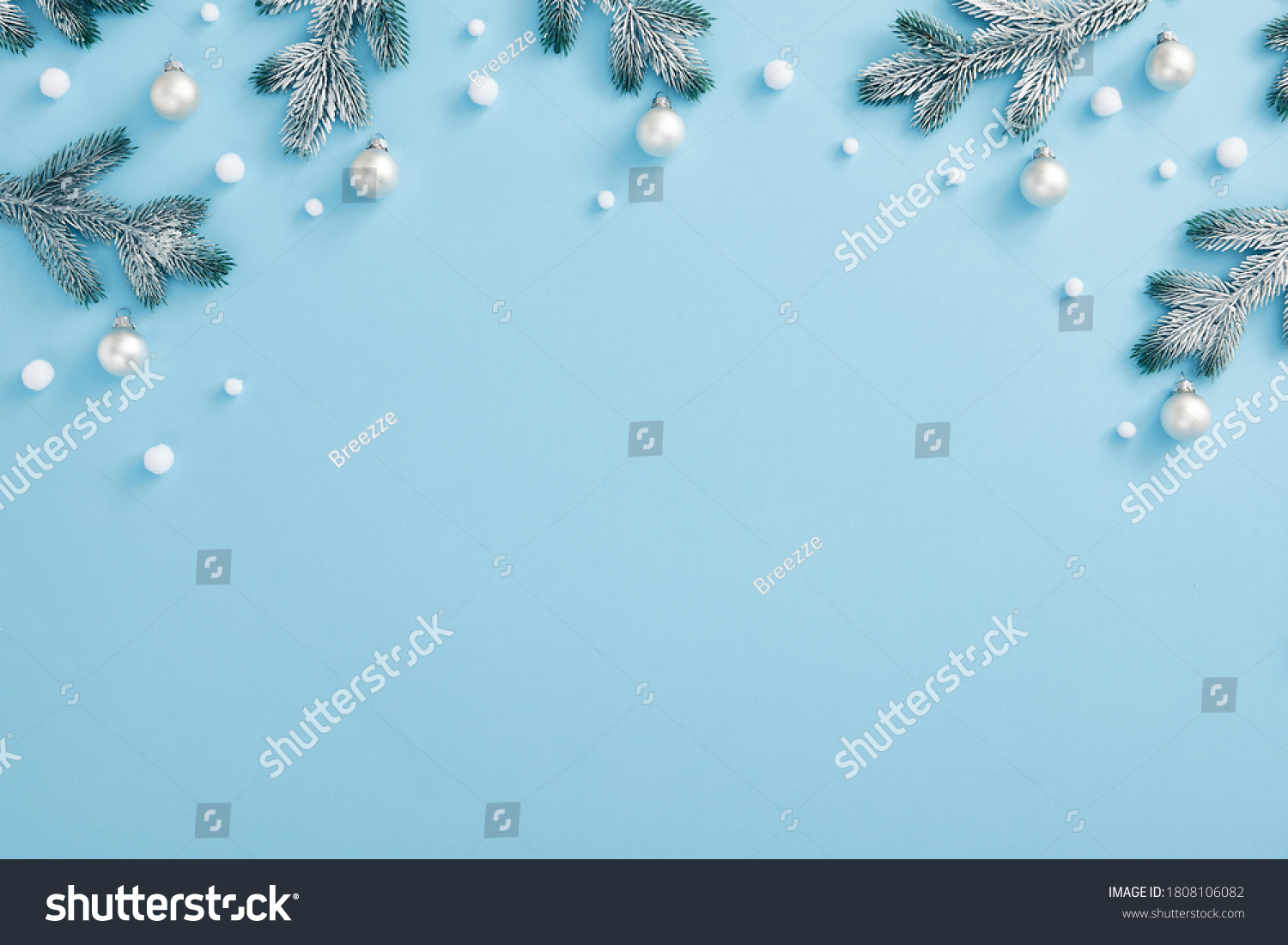 Christmas minimal concept - Christmas composition with snowy fir branch and white bauble. Horizontal top composition, flat lay, view from above. Pastel blue background with copy space #1808106082