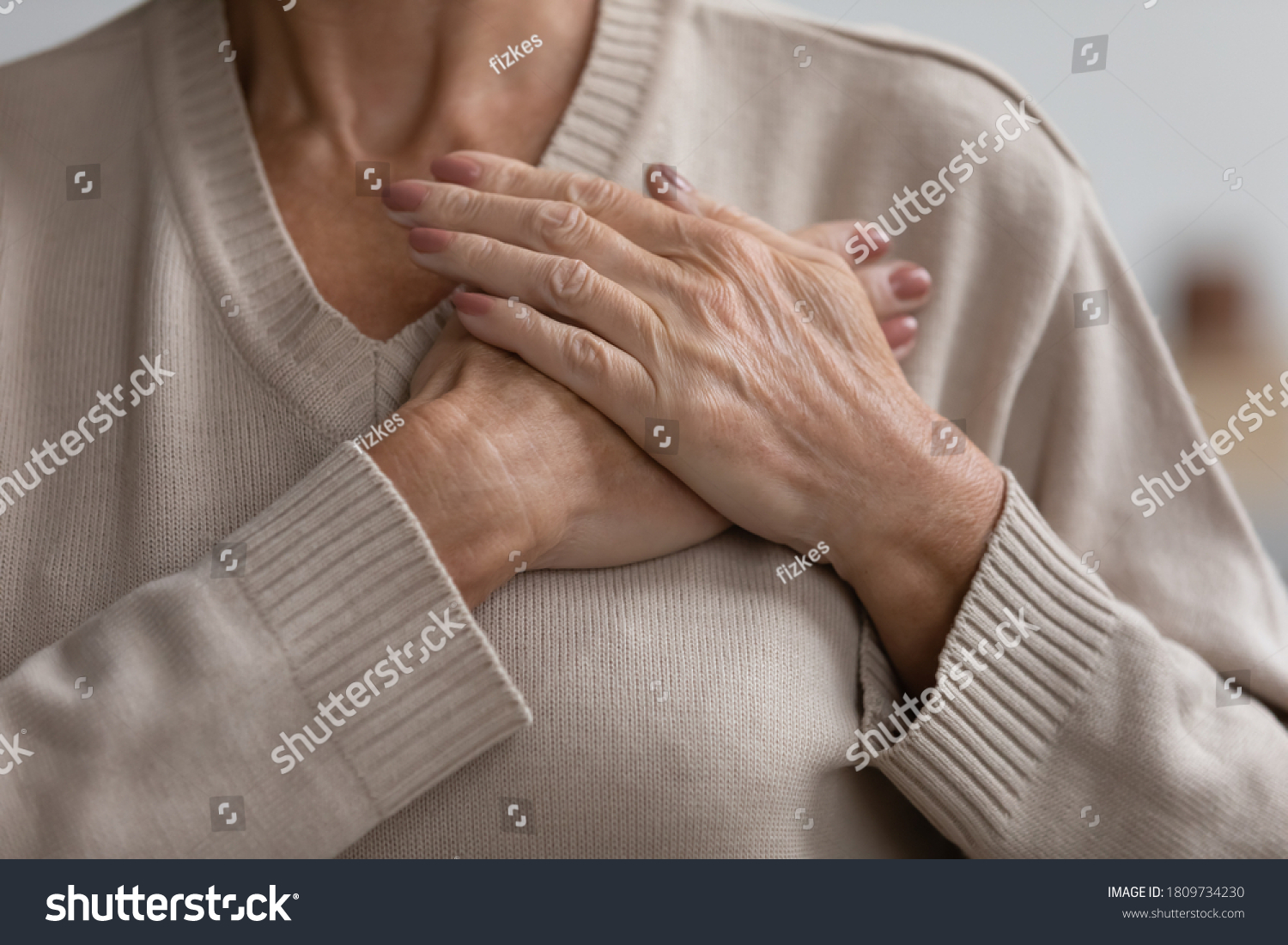 Close up cropped image hopeful grateful mature senior woman keeping hands on chest, mindful middle aged female thanking god and faith, feeling love, gratitude, appreciation, making wish #1809734230