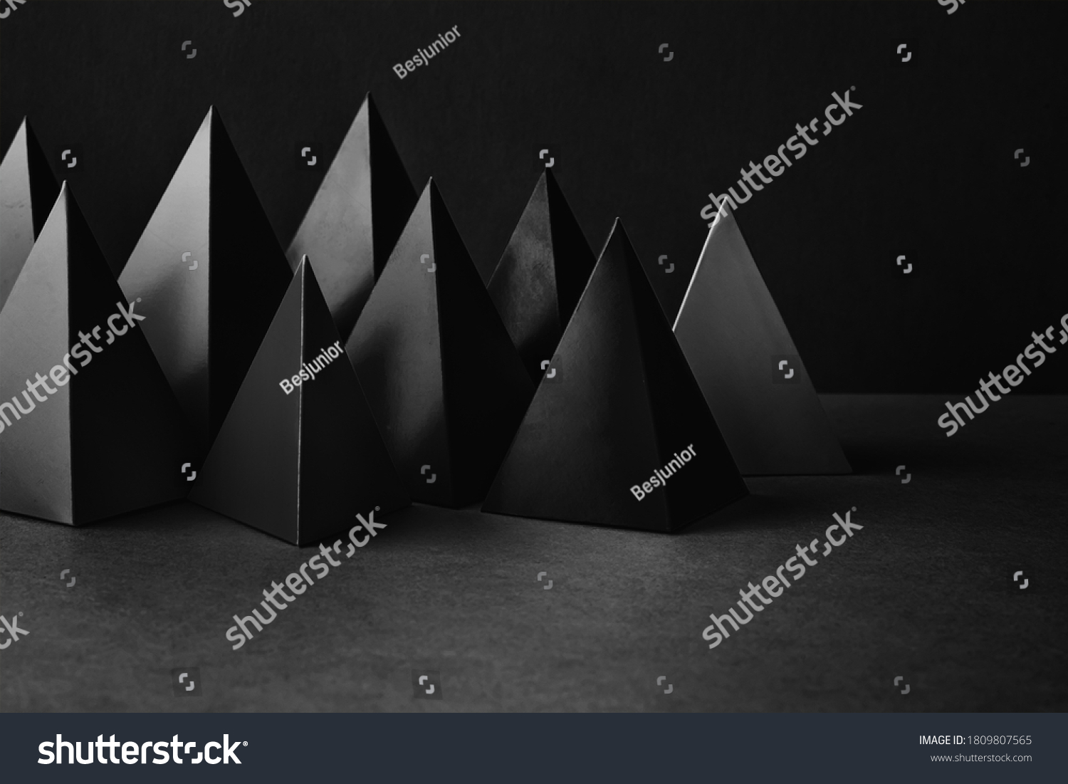 Prism pyramid objects on black gray background. Abstract geometrical figures still life composition #1809807565