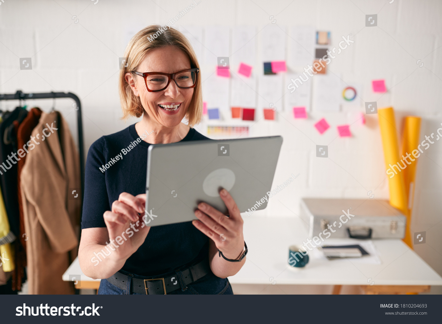 Mature Businesswoman Using Tablet Computer In Studio Of Start Up Fashion Business #1810204693