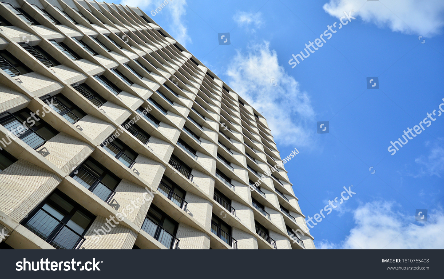 Exterior of a modern multi-story apartment building - facade, windows and balconies. #1810765408