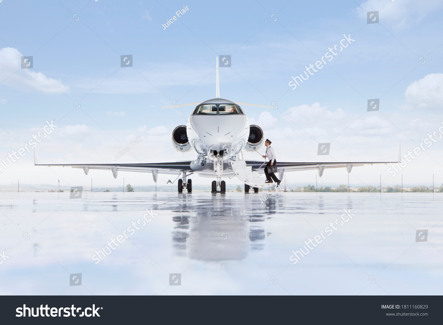 A wide shot of pilot boarding a private jet on a runway. #1811160829