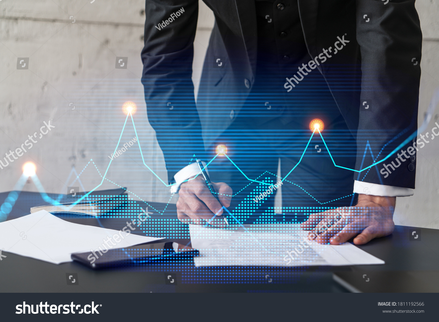 Businessman in suit signs contract. Double exposure with financial chart hologram. Man signing mortgage agreement. Real estate market analysis and investment concept. #1811192566
