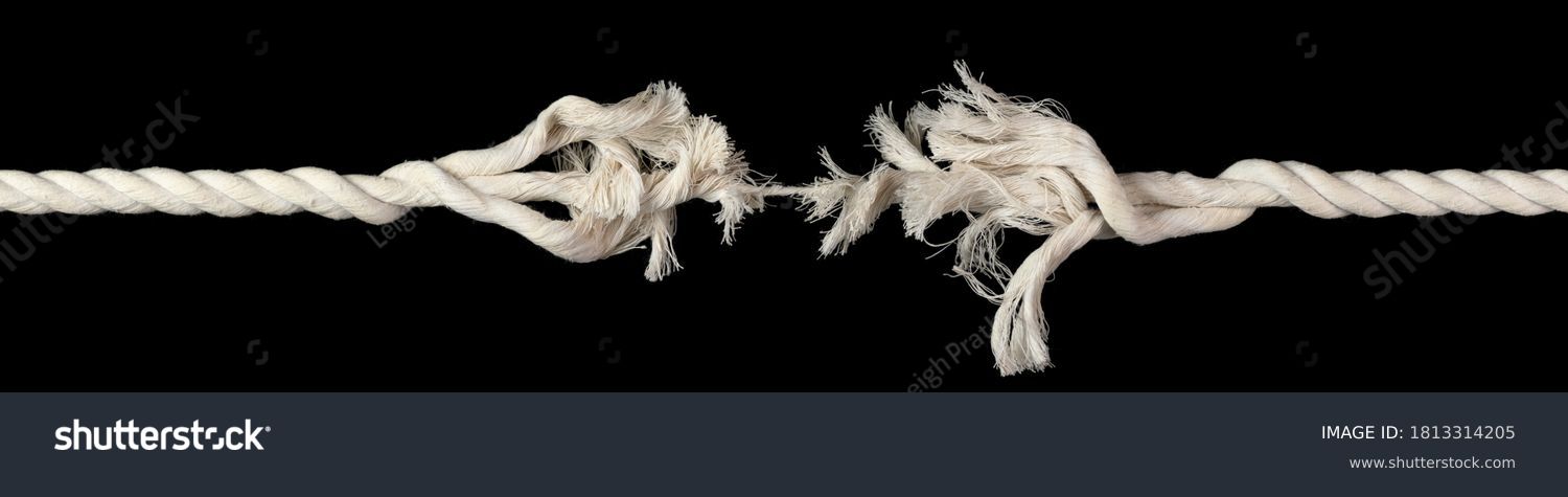 Cotton rope, frayed and ready to break apart with rope held together by last strand ready to snap. Concept of danger or stressful situation like divorce separation, deadlines, failure, or tension. #1813314205