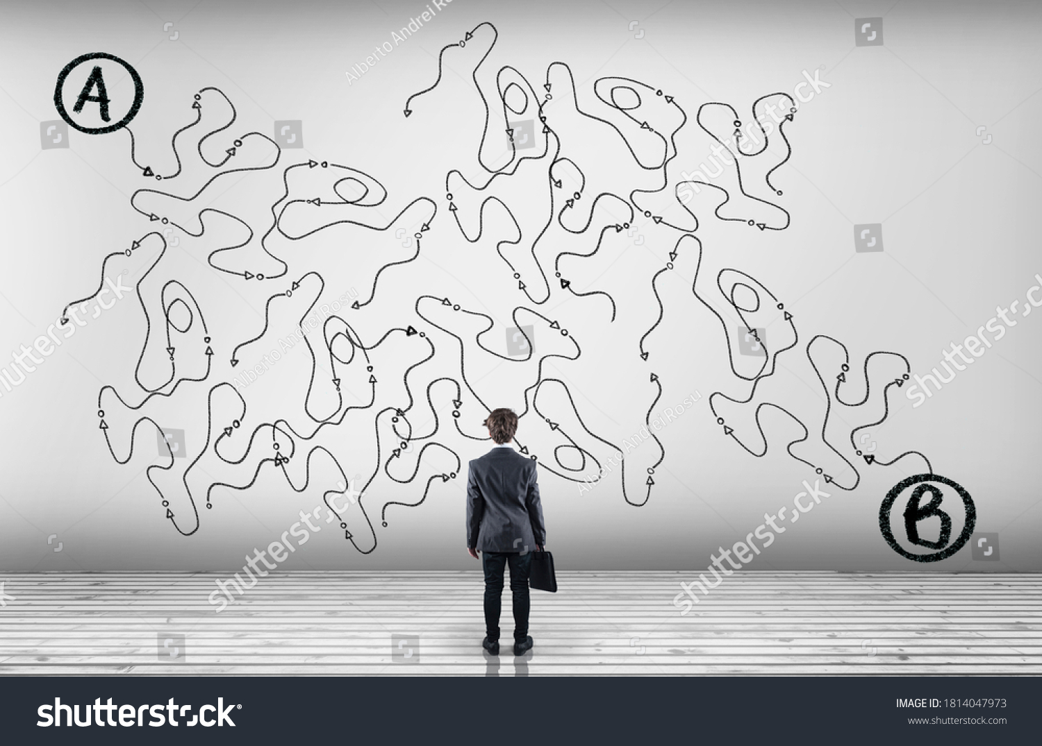 Businessman looking at a complicated path of point to point b .  #1814047973