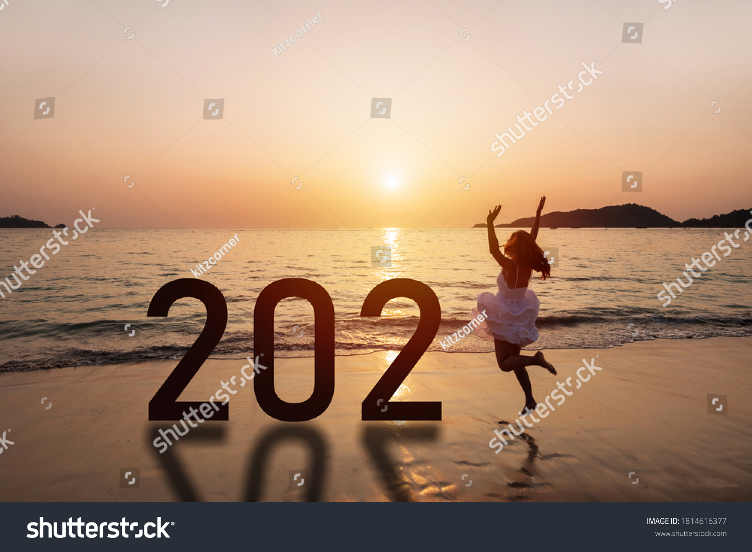 Young woman traveler jumping at the beach celebrating New Year 2021 at sunset #1814616377