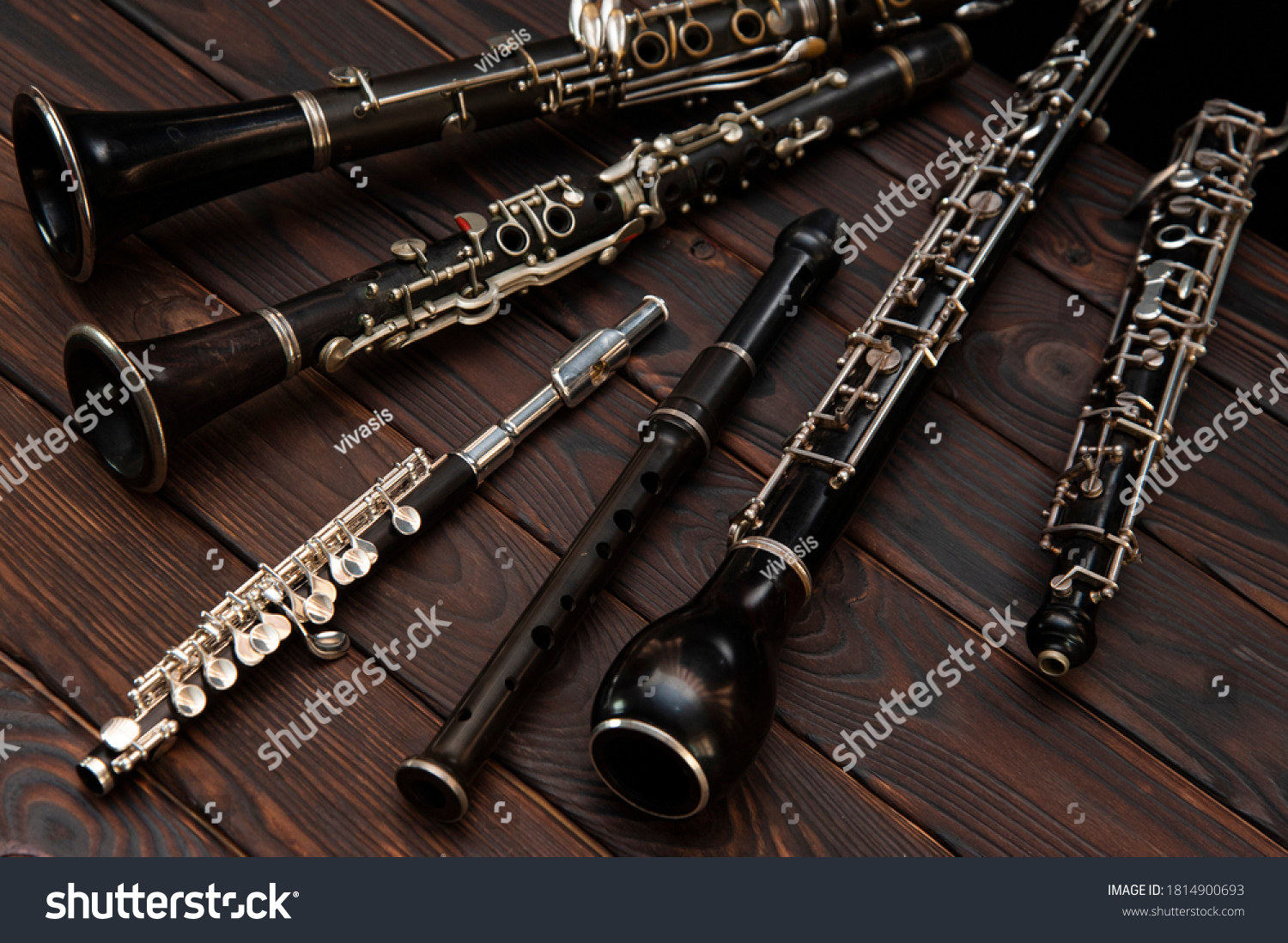 Woodwind instruments lie on a wooden surface. View from above #1814900693