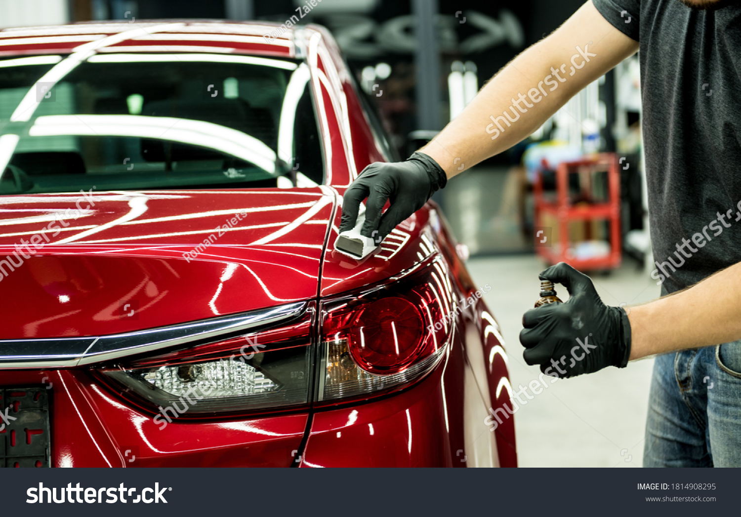 Car service worker applying nano coating on a car detail. #1814908295