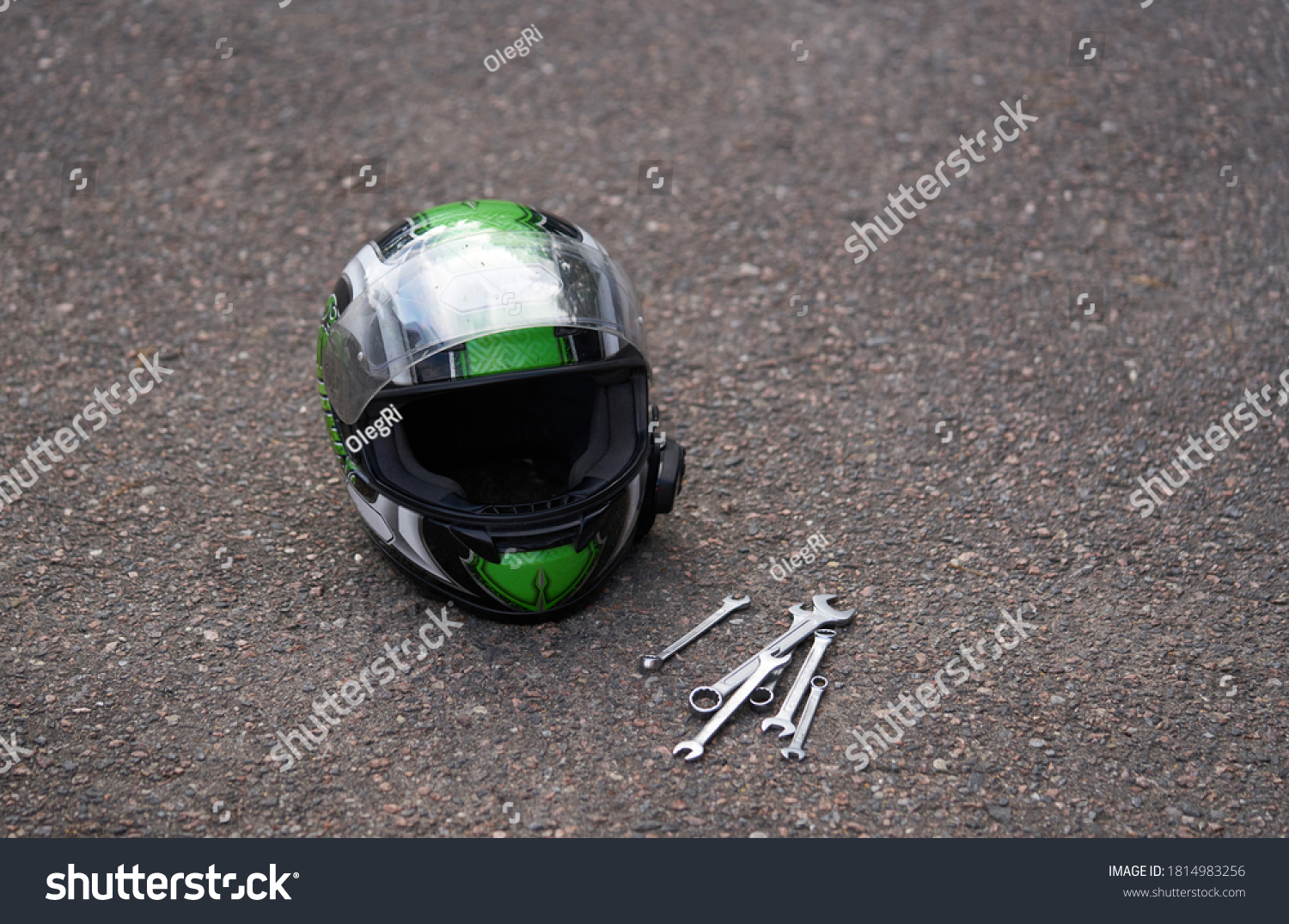 Motorcycle helmet at ground and some wrenches. Wrench at ground #1814983256