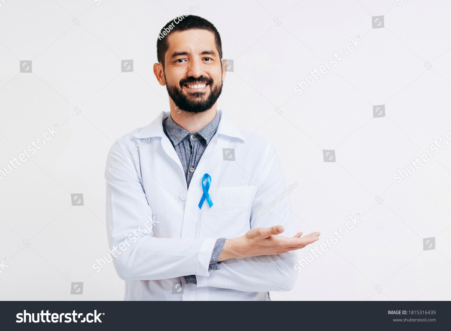 Prostate Cancer Awareness. Doctor man holding light Blue Ribbon for supporting people living and illness. Men Healthcare and World cancer day concept #1815316439