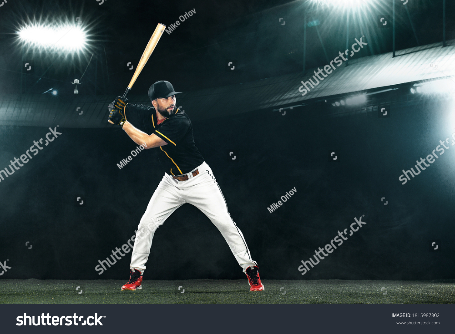 Porfessional baseball player with bat on grand arena. Ballplayer on stadium. #1815987302