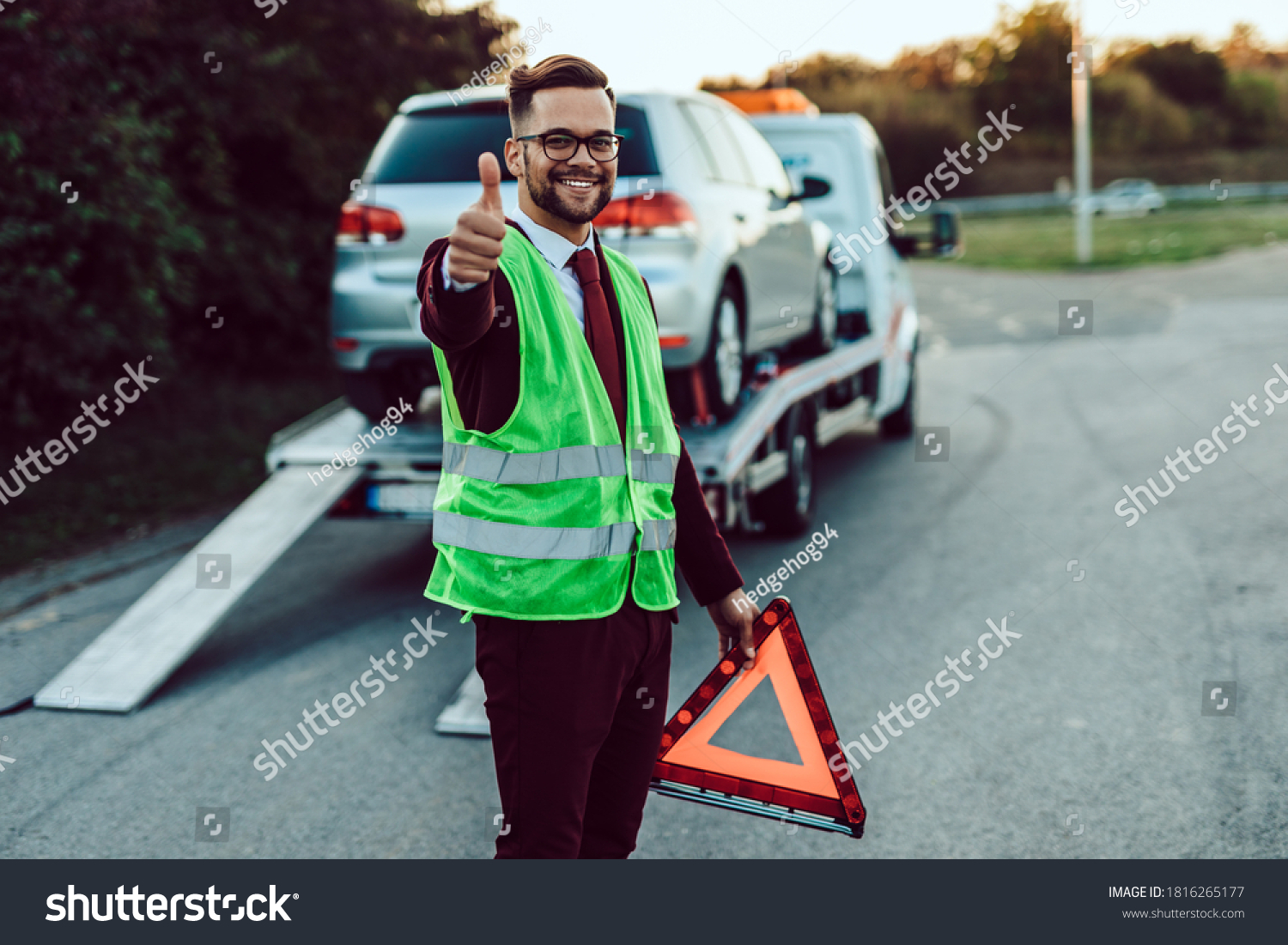 Elegant middle age business man is happy and satisfied with fast towing service for help on the road. He showing thumb up. Roadside assistance concept. #1816265177
