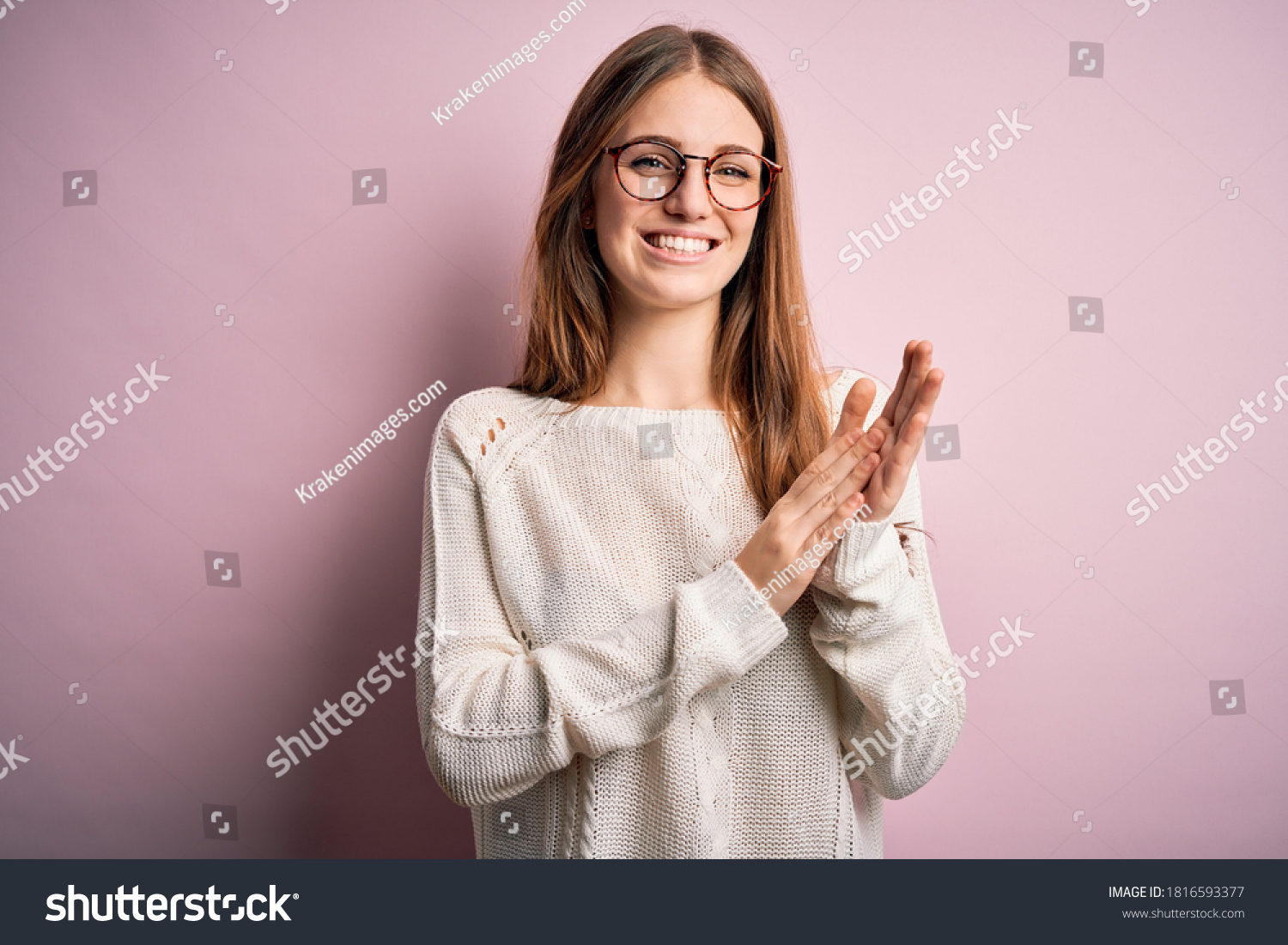 Young beautiful redhead woman wearing casual sweater and glasses over pink background clapping and applauding happy and joyful, smiling proud hands together #1816593377