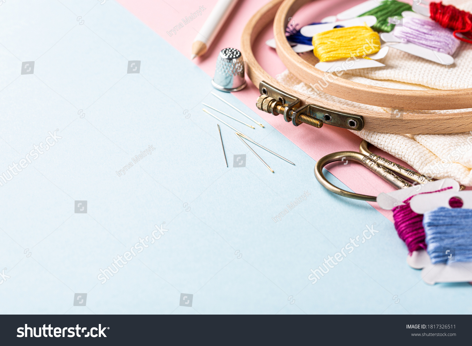 Embroidery set fot cross stitching. White fabric, embroidery hoop, colorful threads, scissors and needls. On blue background. Hobbies concept with copy space. #1817326511