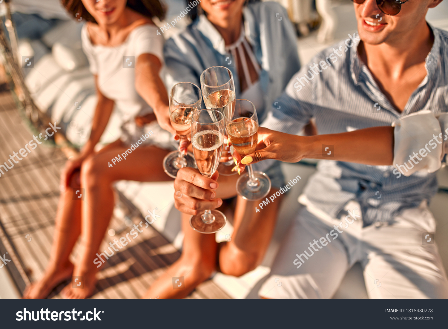 Cheers! Cropped image of group of friends relaxing on luxury yacht and drinking champagne. Having fun together while sailing in the sea. Traveling and yachting concept. #1818480278