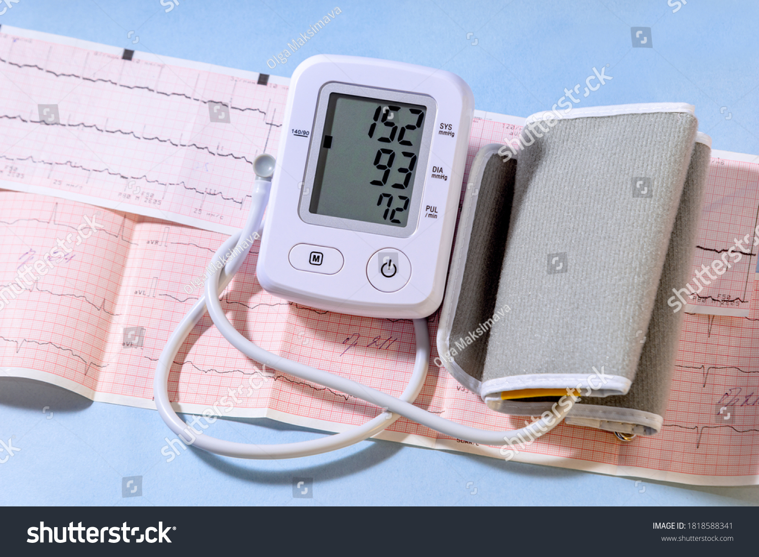 White electric tonometer on a Cardiogram and high pressure value. Medicine concept. #1818588341