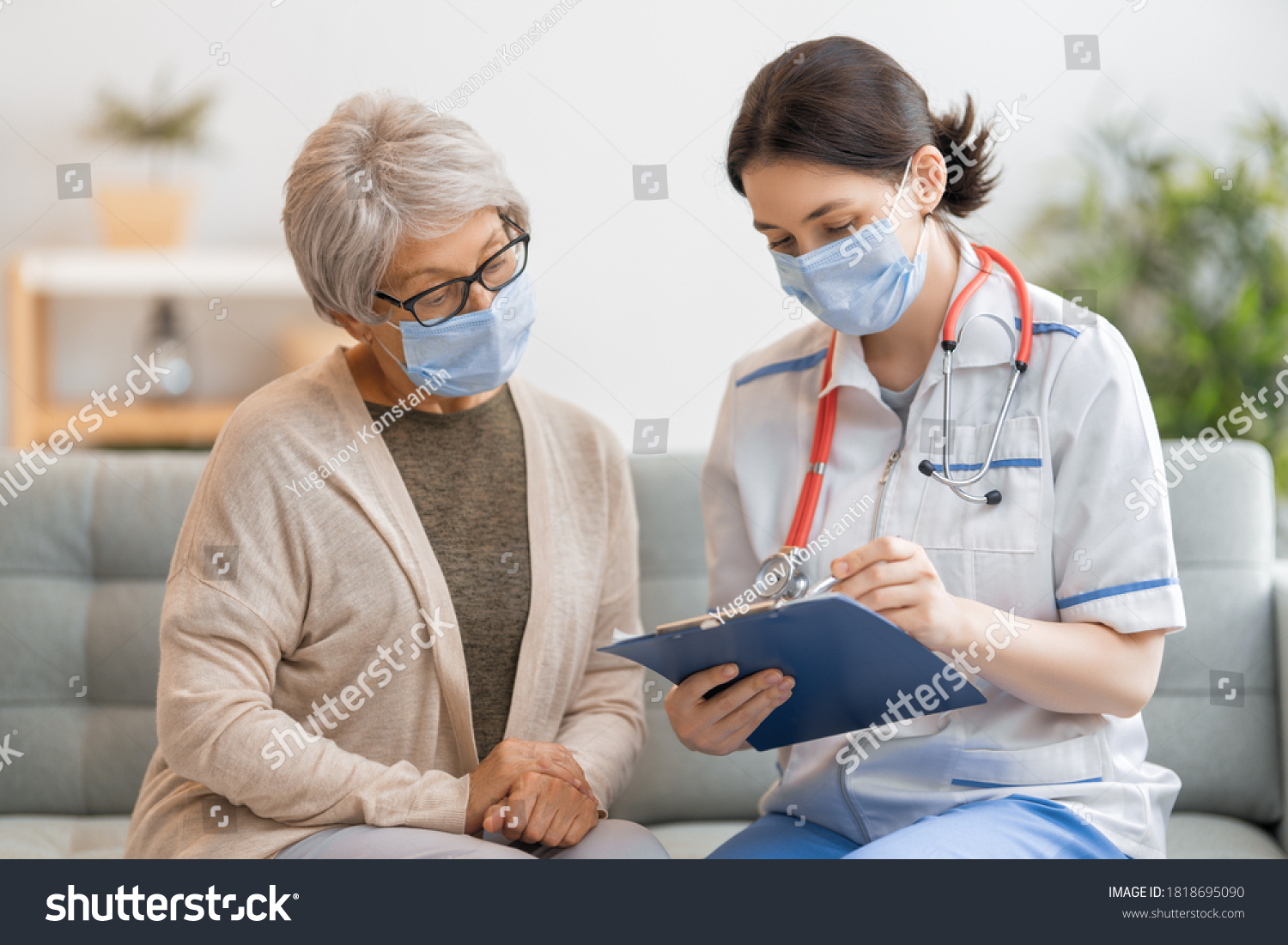 Doctor and senior woman wearing facemasks during coronavirus and flu outbreak. Virus protection. COVID-2019. Taking on masks. #1818695090