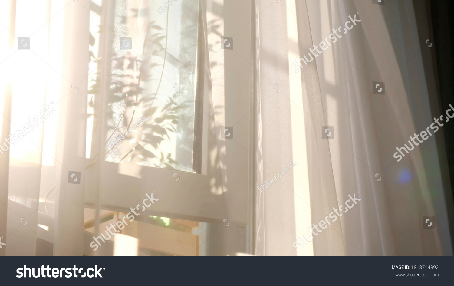 wind blows through the open window in the room. Waving white tulle near the window. Morning sun lighting the room, shadow background overlays. #1818714392