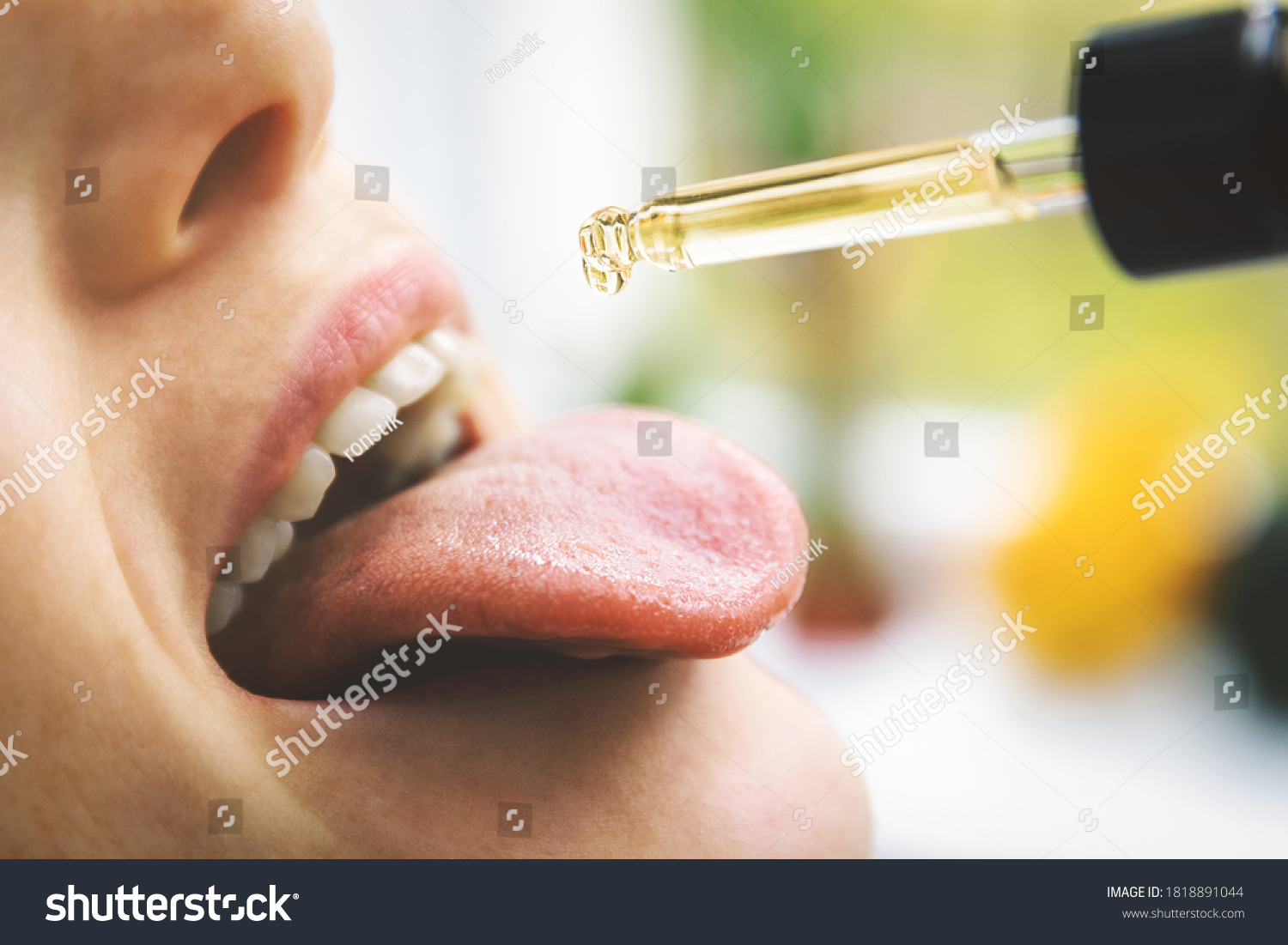herbal alternative medicine and dietary supplements - woman taking cbd hemp oil drops in mouth from dropper. medical cannabis #1818891044