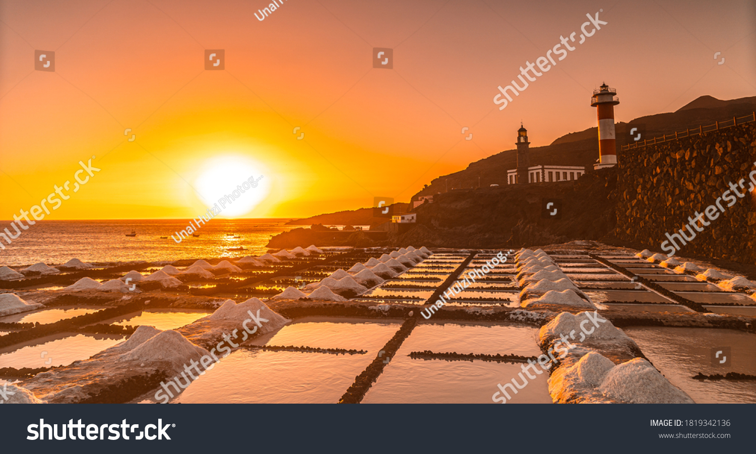 Sunset at the Fuencaliente Lighthouse next to the salt flats, on the route of the volcanoes south of the island of La Palma, Canary Islands, Spain #1819342136