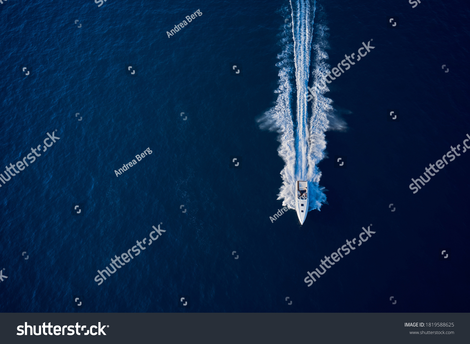 Large speed boat moving at high speed. Top view of a white boat sailing to the blue sea. Drone view of a boat sailing. Motor boat in the sea. Travel - image. #1819588625
