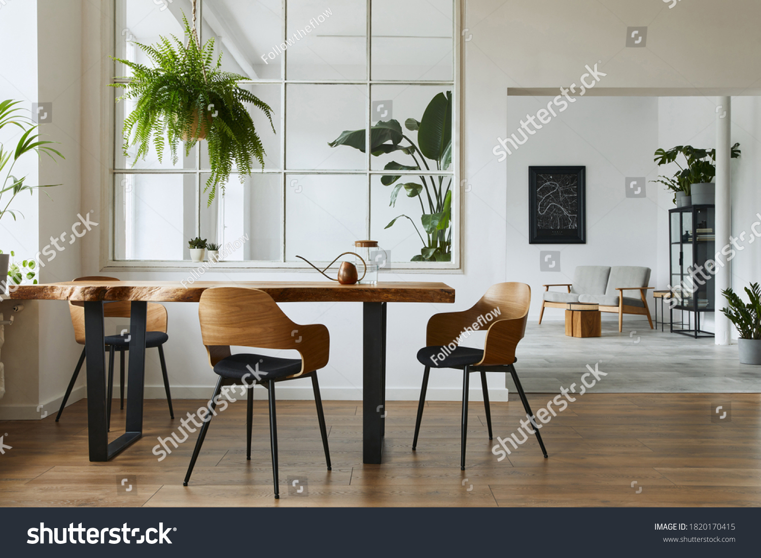Stylish and botany interior of dining room with design craft wooden table, chairs, a lof of plants, big window, poster map and elegant accessories in modern home decor. Template. #1820170415